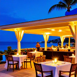 Caribbean Holidays, Adults Only Holidays, Elegant open-air restaurant in Grand Case, Saint Martin, tables by the sea and colourful Caribbean evening light