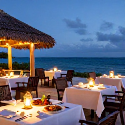 Caribbean Holidays, Adults Only Turks, Elegant beachfront restaurant in Turks and Caicos at dusk, tables lit by lanterns, fresh seafood and a view of the ocean