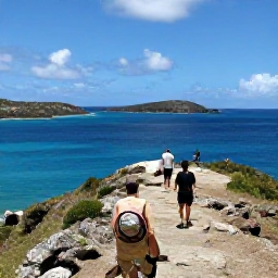 Caribbean Holidays, Antigua Adventure, Travellers hiking along a rugged coastal trail near English Harbour with views across the Caribbean Sea