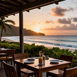 Caribbean Holidays, Antigua Beach Holidays, A relaxed beachfront restaurant in Antigua at sunset, with tables, local food and views across the Caribbean Sea