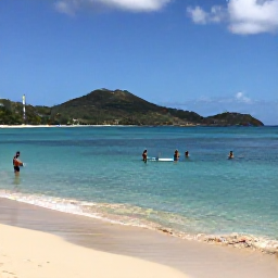 Caribbean Holidays, Antigua Beach Holidays, Visitors swimming and paddleboarding in calm clear Caribbean water beside a sandy Antigua beach, with green hills in the distance