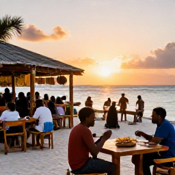 Caribbean Holidays, Antigua July Beaches, A relaxed outdoor beach bar near the sea in Antigua at sunset, with tables, local food and holidaymakers enjoying live music