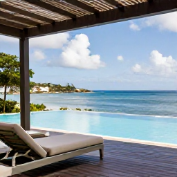 Caribbean Holidays, Antigua Luxury Holidays, An elegant Antigua beachfront suite with an infinity pool, shaded terrace and views across calm blue Caribbean sea