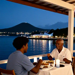 Caribbean Holidays, Antigua Solo Holidays, Friendly outdoor restaurant in Antigua at dusk, solo diner enjoying local Caribbean food beside a softly lit harbour