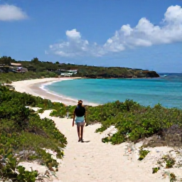 Caribbean Holidays, Antigua Walking Holidays, A peaceful walker on a sandy beach trail near a secluded Antigua bay, with clear blue water and low green vegetation