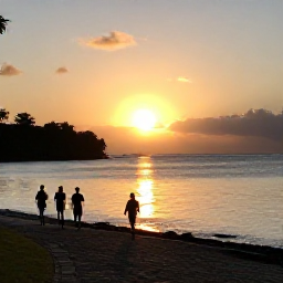 Caribbean Holidays, Antigua Walking Holidays, Golden sunset over Antigua&rsquo;s calm bay with walkers silhouetted on a coastal path