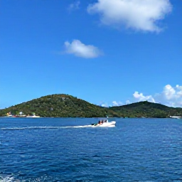 Caribbean Holidays, April Adventures, A small motorboat travelling between green Caribbean islands near St Thomas, with a sunny blue sky and calm sea