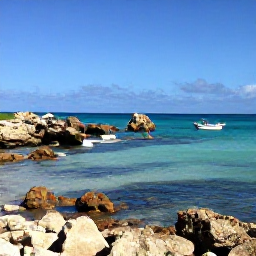Caribbean Holidays, April Adventures, A sunny Cura&ccedil;ao coastline in April with turquoise sea, rugged rocks and a small snorkelling boat near shore