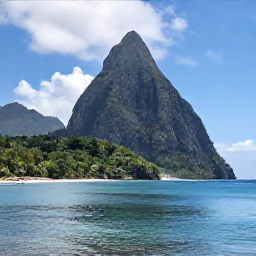 Caribbean Holidays, April Instagram Hotspots, The Pitons of Saint Lucia rising dramatically above a lush green coastline, viewed from a calm blue bay in April