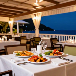 Caribbean Holidays, April Spa Breaks, Outdoor table at a stylish Caribbean restaurant in Grand Case, Saint Martin, with fresh seafood, local dishes and evening lights