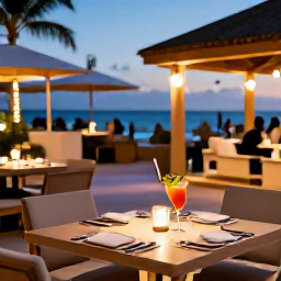 Caribbean Holidays, Aruba Adults Only June, Outdoor dining at an adults-only Aruba resort with tropical cocktails and a warm evening atmosphere