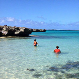 Caribbean Holidays, Aruba Adults Only, Snorkellers exploring clear shallow water near Aruba, with colourful fish and rocky coastline