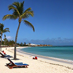Caribbean Holidays, Aruba Beach Holidays, Palm-fringed Eagle Beach in Aruba with sun loungers, clear water and gentle waves on a sunny May day