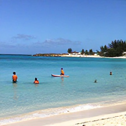 Caribbean Holidays, Aruba Beach Holidays, Visitors swimming and paddleboarding in calm clear Caribbean water beside an Aruba beach