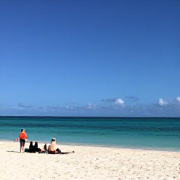Caribbean Holidays, Aruba Business Class, Palm-fringed white beach in Aruba with turquoise water, clear blue sky and travellers relaxing in February sunshine