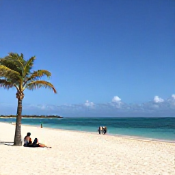 Caribbean Holidays, Aruba February Holidays, Wide sandy beach in Aruba under bright February sunshine, calm turquoise sea, palm trees and a few relaxed holidaymakers