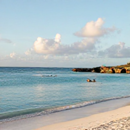 Caribbean Holidays, Aruba in February, A tranquil February afternoon at Arashi Beach in Aruba, with calm turquoise water, snorkellers, pale sand and rocky outcrops