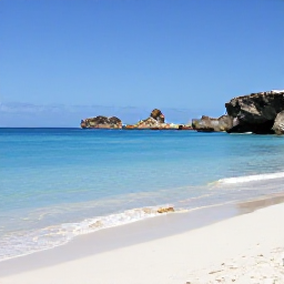 Caribbean Holidays, Aruba in February, Sunny Aruba coastline in February with calm turquoise water, white sand, rocky natural landscape and a clear blue sky