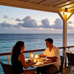 Caribbean Holidays, Aruba in June, Romantic open-air restaurant in Aruba at dusk, couple dining with ocean view and softly lit tables