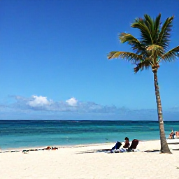 Caribbean Holidays, Aruba in September, A sunny Caribbean beach in Aruba with calm turquoise sea, white sand, palm trees and a few relaxed holidaymakers