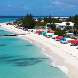 Caribbean Holidays, Aruba Instagram Hotspots, Aerial view of Aruba's turquoise coastline, white sand beaches and colourful beach huts in bright Caribbean sunlight