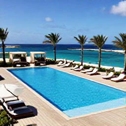 Caribbean Holidays, Aruba Luxury Holidays, An elegant Aruba hotel pool overlooking the Caribbean Sea, with palm trees, private cabanas and guests relaxing