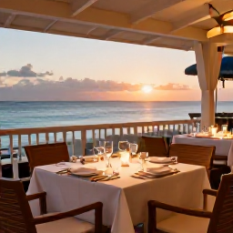 Caribbean Holidays, Aruba Luxury Holidays, Elegant beachfront restaurant in Aruba at sunset, with a beautifully set table, soft lighting and views across the Caribbean Sea