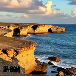 Caribbean Holidays, Aruba September Holidays, Travellers exploring Aruba&rsquo;s rugged north coast near natural rock formations, golden light, blue sea and dramatic desert landscape