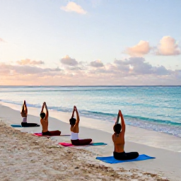 Caribbean Holidays, Aruba Wellness, Visitors practising yoga on a quiet sandy Aruba beach at sunrise, gentle poses, turquoise water and soft morning light