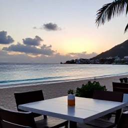 Caribbean Holidays, August Adventures, Outdoor table at a relaxed Caribbean restaurant overlooking a beach in Saint Martin at sunset