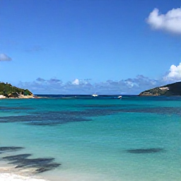 Caribbean Holidays, August Beach Holidays, Small boat cruising past green Caribbean coastline and secluded coves around Saint Martin and Sint Maarten on a sunny August day