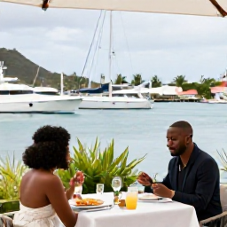 Caribbean Holidays, August Honeymoons, Couple enjoying a relaxed outdoor lunch at a stylish waterfront restaurant in Gustavia, Saint Barth&eacute;lemy, harbour and yachts behind them