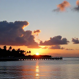 Caribbean Holidays, August Hotspots, A dramatic sunset at Rum Point in Grand Cayman, with calm Caribbean water, a wooden jetty and palm trees under a warm evening sky