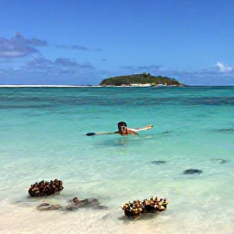 Caribbean Holidays, August Island Hopping, Traveller snorkelling in clear turquoise water near a quiet Grenadine beach, with coral, tropical fish and a small island beyond