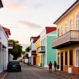 Caribbean Holidays, August Solo Holidays, Colourful Charlotte Amalie streets with historic buildings, independent shops and a solo traveller exploring in warm Caribbean weather