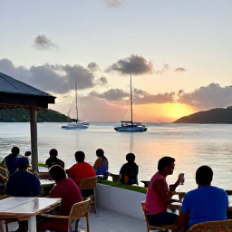 Caribbean Holidays, August Walking Holidays, Travellers relaxing at a waterfront restaurant in the British Virgin Islands after a day's walking, with boats in a calm bay at sunset