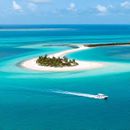 Caribbean Holidays, Bahamas Adventure Holidays, Aerial view of turquoise Bahamian water, white sand islands and a small boat travelling between them in bright natural sunlight