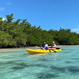 Caribbean Holidays, Bahamas Adventure Holidays, Visitors kayaking through clear shallow water beside mangroves in the Bahamas under a sunny blue sky