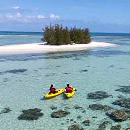 Caribbean Holidays, Bahamas Beach Holidays, A couple kayaking over clear shallow water beside a small island in the Bahamas, with coral reefs visible below