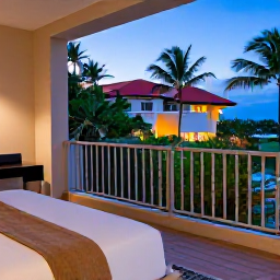 Caribbean Holidays, Bahamas City Breaks, Comfortable Nassau hotel room opening onto a balcony with tropical garden and evening light