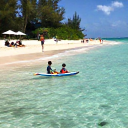 Caribbean Holidays, Bahamas Family Holidays, Children paddling in clear shallow water while parents relax on a sandy beach in The Bahamas, colourful fish visible near the shore