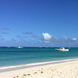 Caribbean Holidays, Bahamas February Tours, Bright turquoise sea, white sand beach and a small boat near Nassau in The Bahamas during sunny February weather