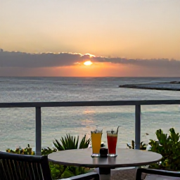 Caribbean Holidays, Bahamas in October, Romantic Bahamian sunset viewed from an adults-only resort terrace, calm ocean and two drinks on a table