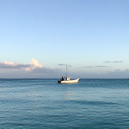Caribbean Holidays, Bahamas January Fishing, A calm turquoise Bahamian sea at sunrise, with a small fishing boat heading towards the horizon
