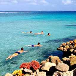 Caribbean Holidays, Bahamas January, Travellers swimming and snorkelling in crystal-clear turquoise water beside a colourful coral reef in The Bahamas