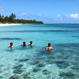 Caribbean Holidays, Bahamas January, Visitors snorkelling over a clear Bahamian reef with colourful fish, with a sunny island coastline in the background