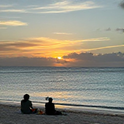 Caribbean Holidays, Bahamas Multi-Centre, A relaxed evening on a Bahamian beach with travellers watching a golden sunset over calm turquoise water