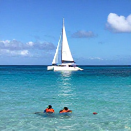 Caribbean Holidays, Barbados Adventure Holidays, A small catamaran sailing beside the west coast of Barbados, with snorkellers in clear water and colourful tropical fish below