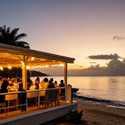 Caribbean Holidays, Barbados City Breaks, Sunset over Bridgetown, Barbados, with diners at an open-air waterfront restaurant and warm lights reflecting on the sea