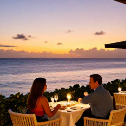 Caribbean Holidays, Barbados Couples Holidays, Elegant Barbados seaside restaurant at sunset with a couple dining outdoors, soft lights and a calm Caribbean sea